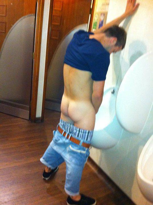 dude peeing urinal