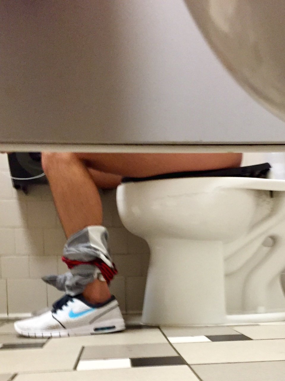 Following a sporty guy inside the gym bathroom picture