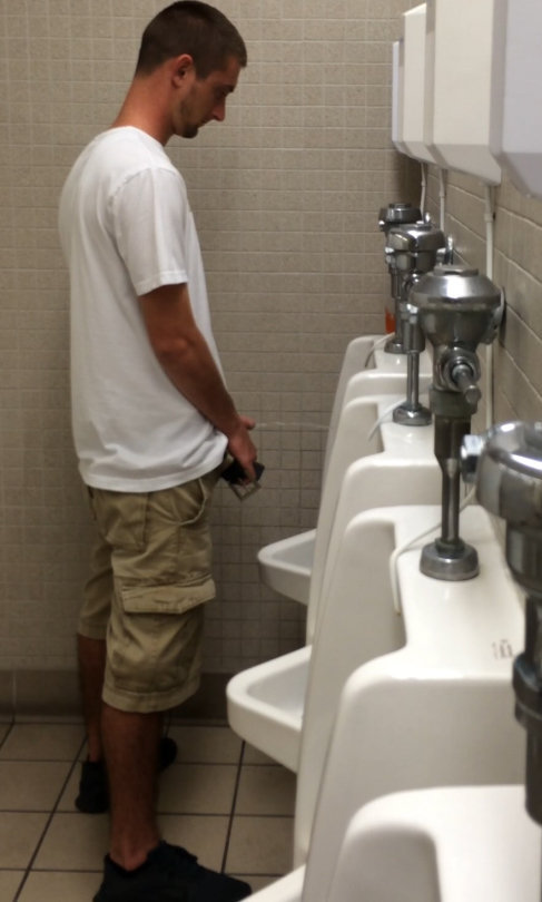 guy caught peeing urinal