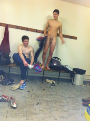 Hot dude standind naked on the bench of the soccer lockerroom
