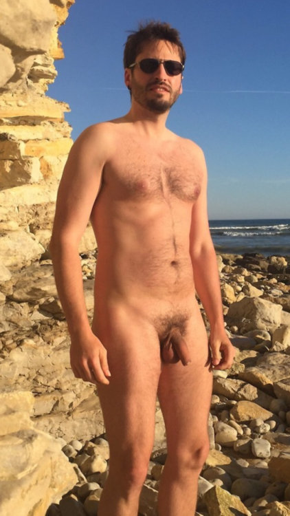 A lovely man naked on the rocks