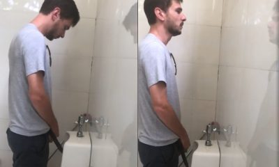 guy wearing slippers caught peeing at urinals
