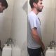 guy wearing slippers caught peeing at urinals