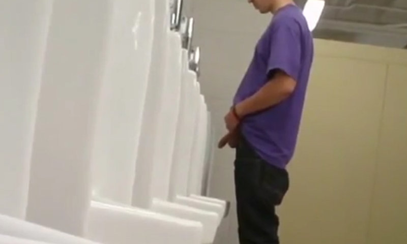 guy peeing at urinal with balls and cock out