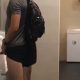 athletic guy caught peeing at urinal
