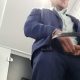 guy in suit caught peeing in public toilet