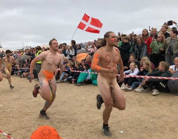 Danish guys running naked for the Roskilde festival.