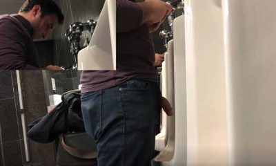 man with big cock peeing at airport urinal