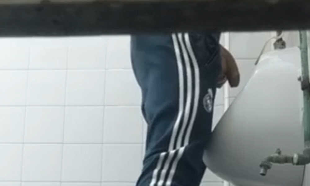 spy under stall on hung guy peeing at urinal