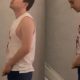guy in tank top caught peeing at urinals