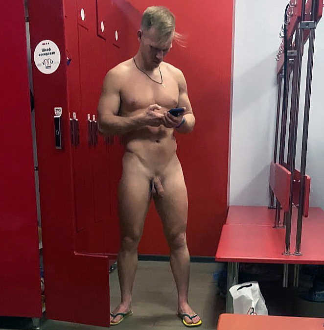 guy texting with phone totally naked in gym locker room