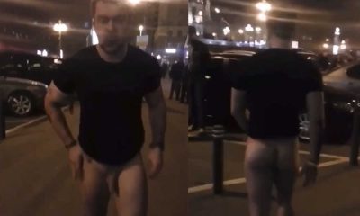 straight drunk guy naked in the street with lot of people
