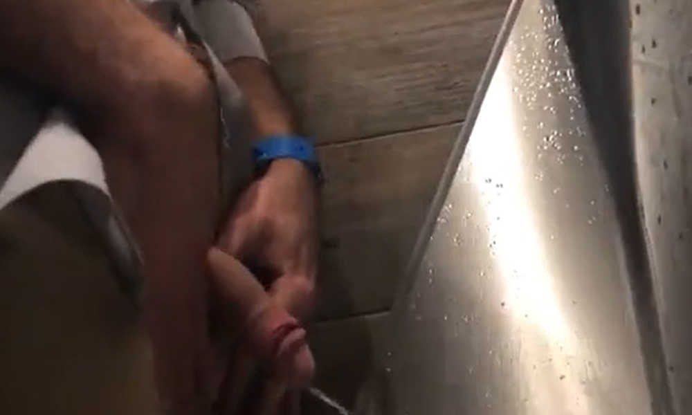 hung uncut guy caught peeing and playing with foreskin