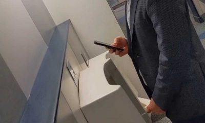 sexy businessman peeing and playing with cock at the urinals