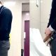 uncut guy in suit caught peeing at the urinals