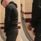 straight lad in shorts taking a pee at urinals