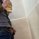 Man peeing at urinals exposing his balls too