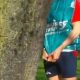 Lad caught peeing behind a tree during a race