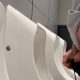 Ginger guy shaking his dick after peeing at the urinals