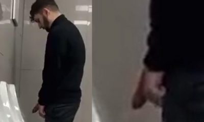 Bearded guy with huge cock caught peeing at the urinals