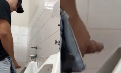 Brazilian dude shaking his big dick at urinals