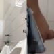 Brazilian dude shaking his big dick at urinals