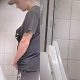 Sporty lad pulling out his dick and peeing at urinals