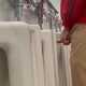 Guy peeing and shaking his dick at airport urinals