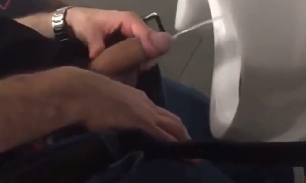 Delicious uncut cock releasing a stream of piss at urinals