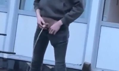 Guy unzipping his trousers and peeing in public