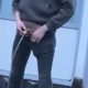 Guy unzipping his trousers and peeing in public
