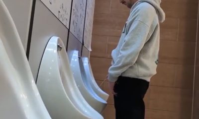 Spying guy peeing at UK urinals