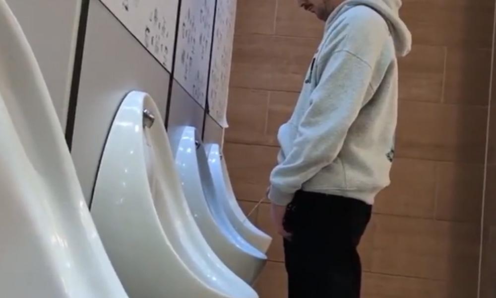 Spying guy peeing at UK urinals