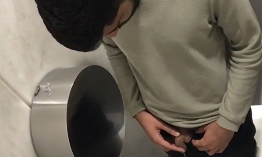 Bearded guy caught peeing in a public toilet by a spycam