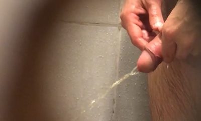 Man pissing in the gym shower