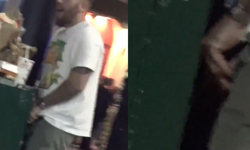 Guy caught peeing in a bin in the street