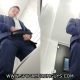 business guy in suit caught peeing in public toilet