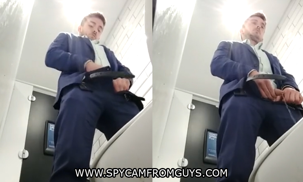 business guy in suit caught peeing in public toilet