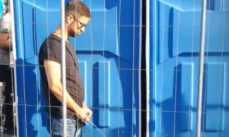 handsome guy caught peeing in public during festival
