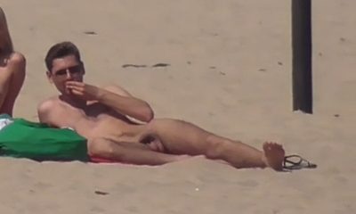nudist guy sunbathing naked at the beach