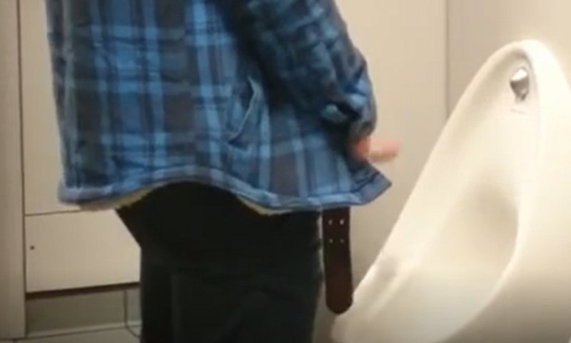 guy peeing and playing with foreskin at urinals