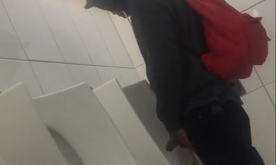 hung guy caught taking a pee at urinal