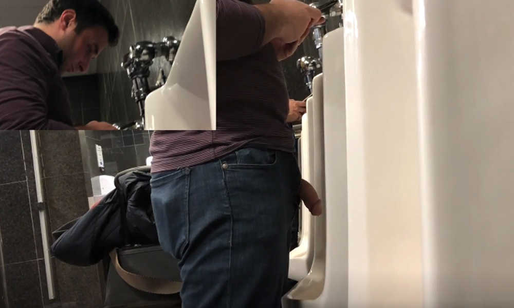 man with big cock peeing at airport urinal