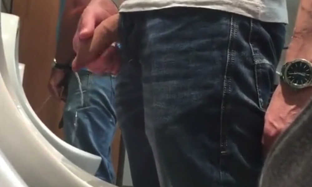 uncut guy with lot of foreskin peeing at urinal