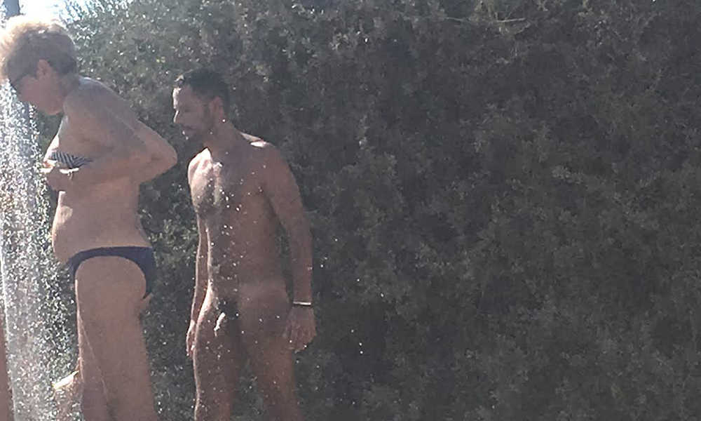 nudist man showering at the naturist beach