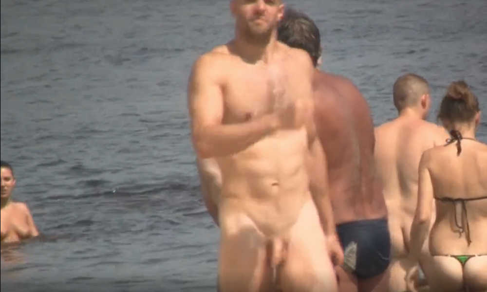 sexy man caught naked over nudist beach