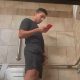 guy with big dick texting and peeing in public toilet