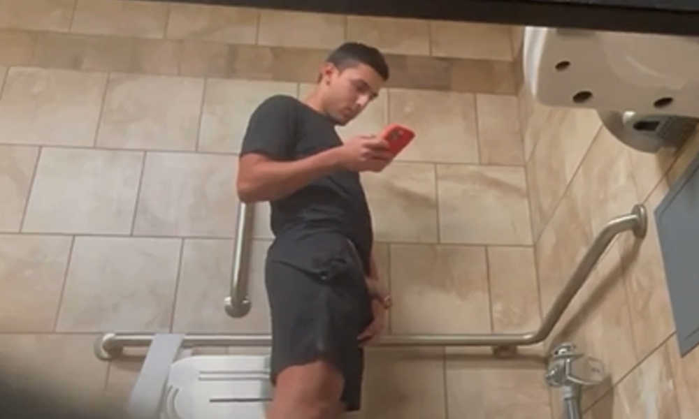 guy with big dick texting and peeing in public toilet
