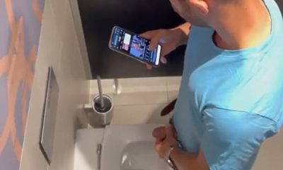 guy jerking off in public toilet while watching porn vids on his mobile phone