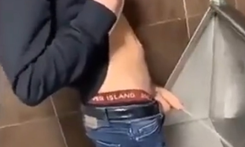 proud guy shows off his huge cock while peeing at urinals